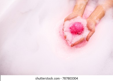 ball of salt dissolves in water. Colored bath bombs