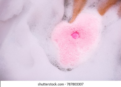 ball of salt dissolves in water. Colored bath bombs