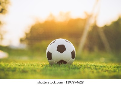 A ball for street soccer football under the sunset ray light. Film picture style. - Powered by Shutterstock