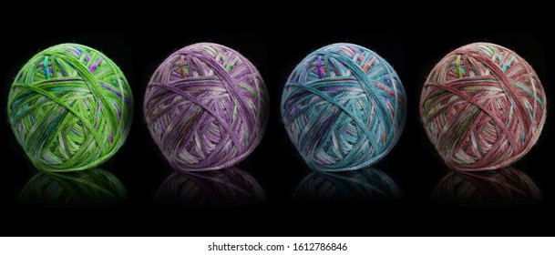 A ball of thread for knitting and on a knitting machine on a black background, needlework, knitting.