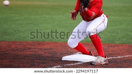 Ball thrown from the outfied to the third baseman to tag out the runner during a high school baseball game.