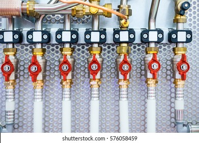 A lot of ball valves, arranged in a row. Detail of the distributor of plumbing system.