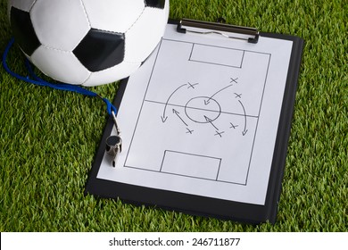 Ball; Whistle And Soccer Tactic Diagram On Paper Over Pitch - Powered by Shutterstock