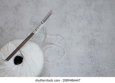 A Ball Of White Yarn, Knitting Needles, White Background