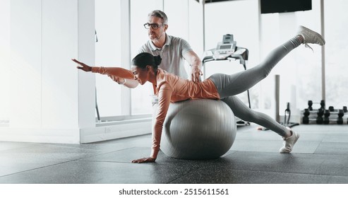 Ball, woman and personal trainer in gym for stretching, rehabilitation and balance training. Man, client and physiotherapy in fitness center for core strength, practice and help in exercise activity - Powered by Shutterstock