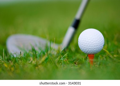 ball and wood of golf on the grass