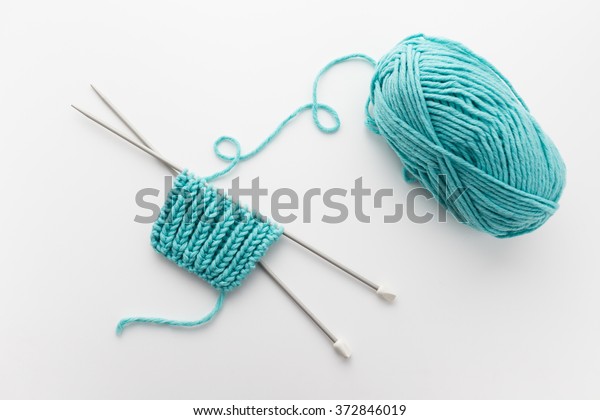 ball of yarn with knitting needles