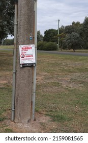 BALLARAT, AUSTRALIA - March 20, 2021: Red And White Sign Warning Of Rabbait 1080 Poison Laid To Cull Pest Wild Rabbits Causing Environmental Damage