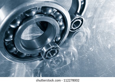 ball-bearings, pinions mirrored in titanium background