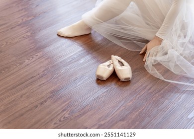 Ballerina in ballet shoes. Asian girl tying ribbons of toe shoes. ballet dancer preparing and wearing ballet shoes in dance studio prepares for a rehearsal - Powered by Shutterstock