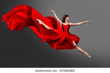 Ballerina Dance. Ballet Dancer in Red Dress jumping Split. Woman in Ballerina Shoes dancing in Silk Gown flying on Wind over Gray Studio Background - Powered by Shutterstock