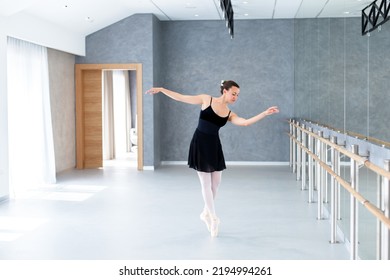 Ballerina Dancing In Ballet Studio On Pointe Shoes. Workout In Ballet Class Room In Classical School. Professional Dancer Doing Exercises Near Barre, Mirror. Graceful Woman Has Modern Dance Practice