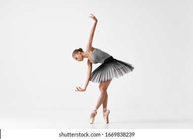 Ballerina Is Dancing On An Isolated Background In Pointe Shoes