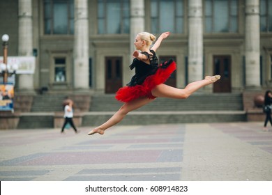 Ballerina doing splits in the air on the square - Powered by Shutterstock