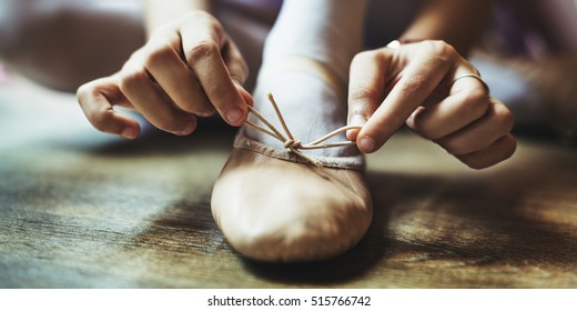 Ballerina Girl Tie Shoes Concept - Powered by Shutterstock