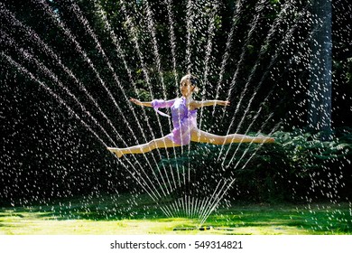 Ballerina leaping through a water sprinkler - Powered by Shutterstock