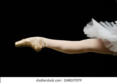 ballerina on point shoes feet tutu on black background isolated - Powered by Shutterstock