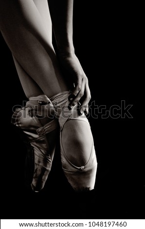 ballerina on point shoes feet on black background black and white isolated