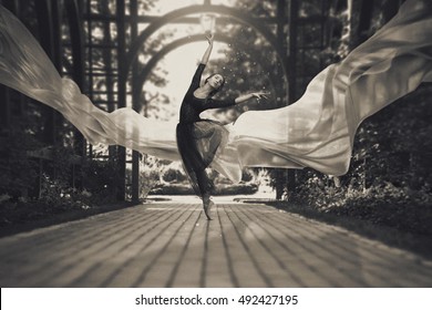 Ballerina Out Of Doors, Young Modern Ballet Dancer Posing. Black And White Photography. The Fabric In The Air