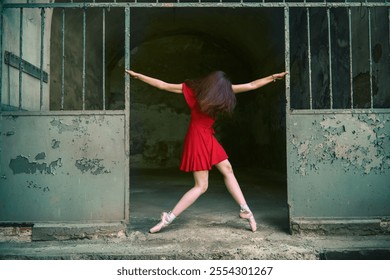 A  ballerina in  red dress performs a dramatic pose in an industrial setting with peeling paint, blending elegance with urban decay for a cinematic effect. - Powered by Shutterstock