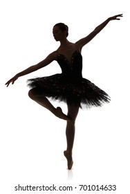 A ballerina silhouette making pirouette against white background, isolated. Professional dancer in tutu skirt. Choreography classes concept