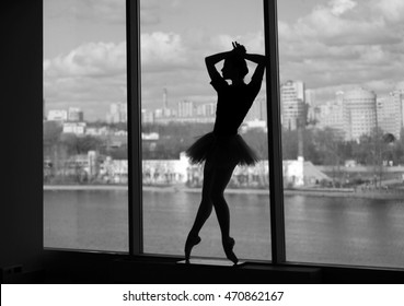 ballerina in a tutu in the window with views of the city - Shutterstock ID 470862167