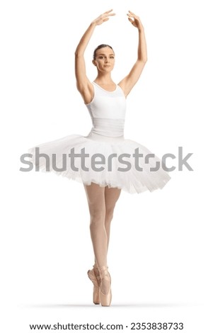 Ballerina in a white tutu dress dancing with arms up isolated on white background