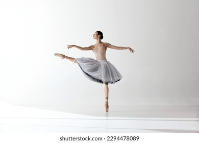 Ballerina. Young graceful woman ballet dancer dressed in professional outfit demonstrating dancing skill. Beauty of classic ballet. Concept of inspiration, beauty, dance, creativity - Powered by Shutterstock