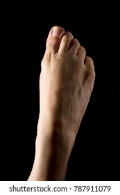 Ballerina's foot close up isolated on black background