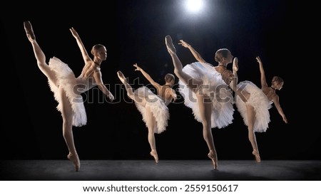 Ballerinas performing under dramatic spotlight, creating striking visual of elegance and movement on stage during classical ballet dance. Concept of classical dance, art, beauty of movements
