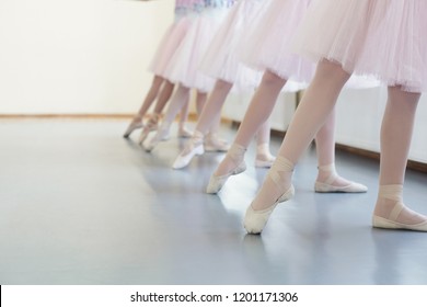 Ballerinas in pointe shoes. Girls stretching legs before dance lessons