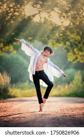ballet boy dancing in the sunset sun on a dirt road in a park	