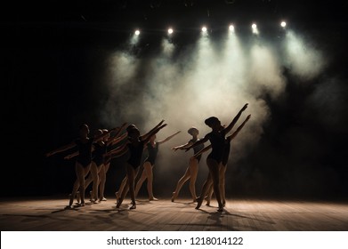 Ballet class on the stage of the theater with light and smoke. Children are engaged in classical exercise on stage. - Shutterstock ID 1218014122