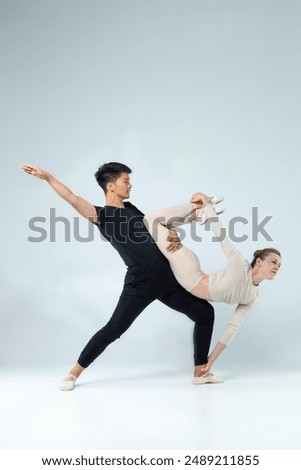 Similar – Image, Stock Photo Vertical composition. Ballerina in the studio at rehearsal. Spotlights and fog in blue tones. Sexually. No face