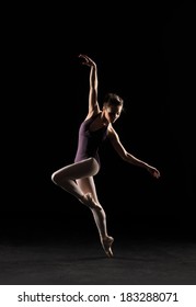 Ballet Dancer In Black Swimsuit At The Studio Background