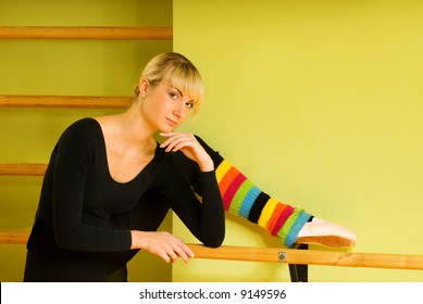 Ballet dancer doing exercise near the bar