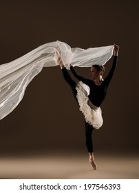 ballet dancer in jump on beige background - Shutterstock ID 197546393