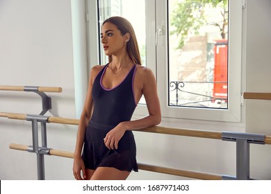 Ballet dancer posing in the dance studio near the window