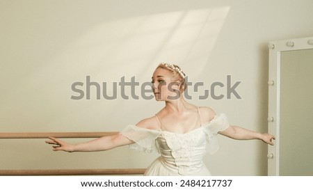 Ballet Dancer Practicing at Barre with Dramatic Lighting