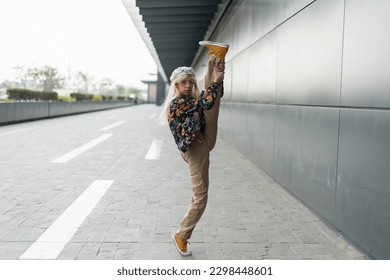 Ballet dancer stretching on the street - Powered by Shutterstock