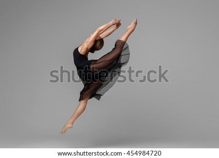Ballet dancer woman black dress on gray background