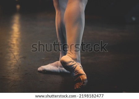 Ballet dancers couple during performance repetition, classic ballet rehearsal practicing in ballroom, view of legs in pointe shoes, ballerina and ballet dancer on a concert hall theatre stage