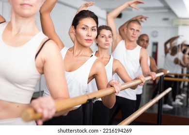 Ballet dancers stands near the ballet barre at the ballet hall. - Powered by Shutterstock