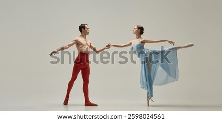 Ballet duet creating dynamic diagonal, one reaching outward, other arching in balance, flowing fabric accentuating movement against white background. Concept of motion, connection, aesthetics.