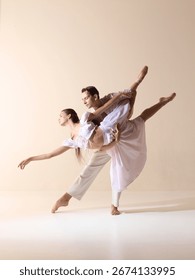Ballet partners in dramatic stretch with elegance and passion. Concept of strength, harmony, stage art, contemporary performance, and expressive storytelling.