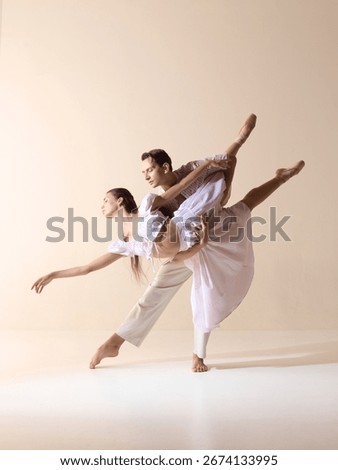 Ballet partners in dramatic stretch with elegance and passion. Concept of strength, harmony, stage art, contemporary performance, and expressive storytelling.