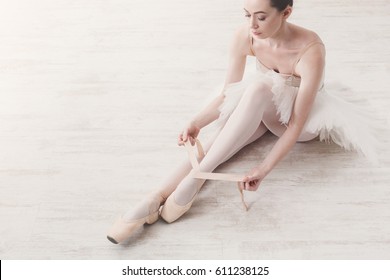 Ballet practice background. Beautiful ballerina dancer top view on white wood floor