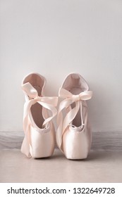 Ballet shoes on floor near wall
