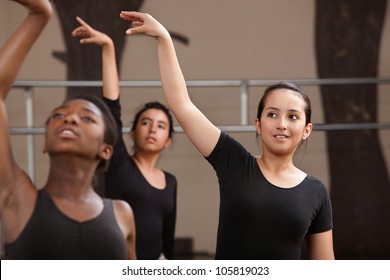 Ballet students rehearsing arm movements during practice