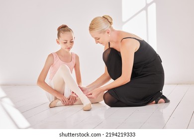 Ballet Teacher, Injured Student And Dance Injury In Class With Dancer Girl Sad About Ankle Pain At Art School. Ballerina Child Performer Getting A Foot Massage During Training For Theatre